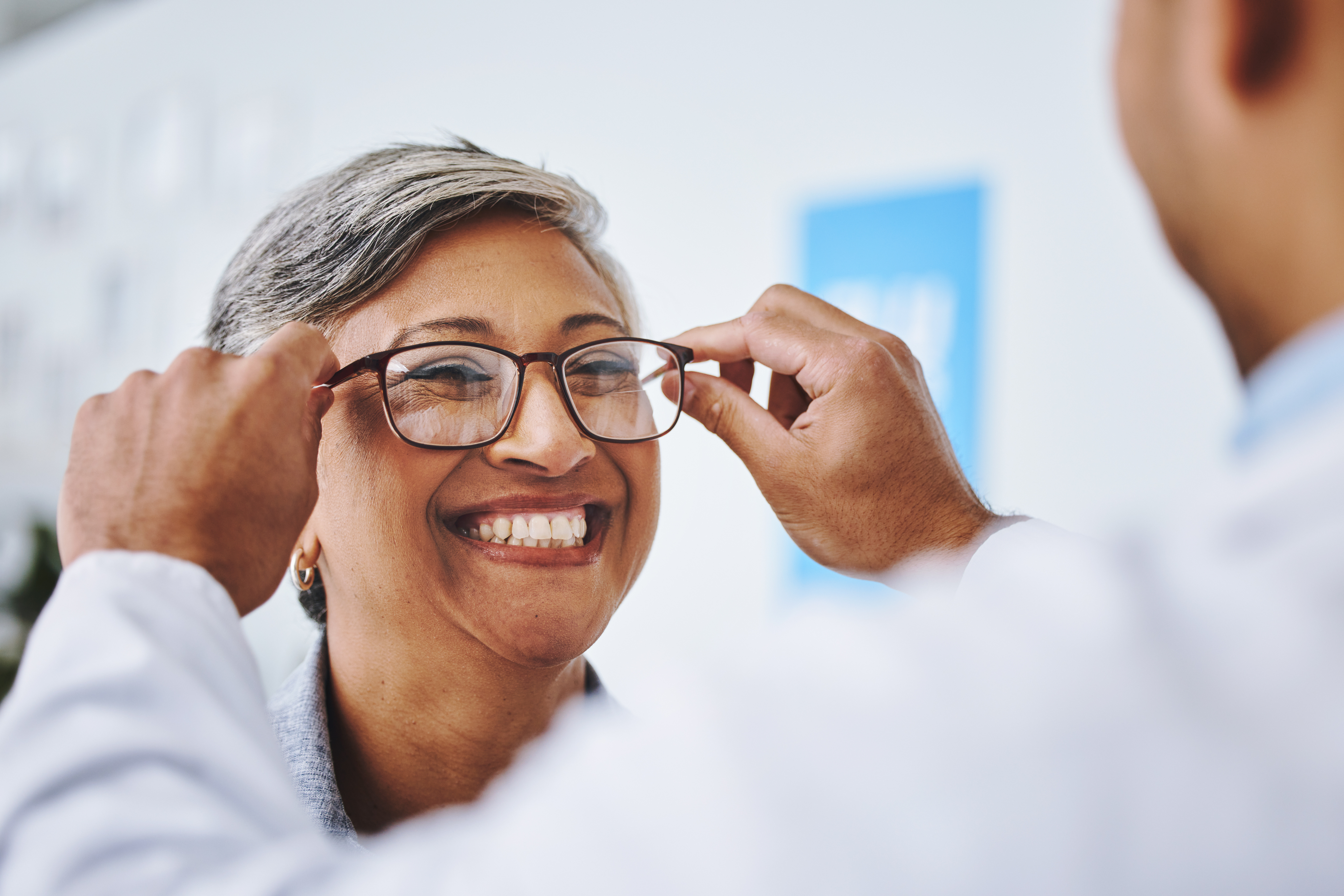 Image of a trusted Albuquerque Optometrist fitting glasses to a patient